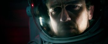 Movie still from “Geostorm” (2017), directed by Dean Devlin – A person wearing a space helmet; Close Up shot, Low angle