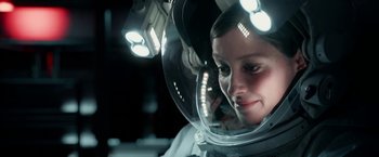 Movie still from “Geostorm” (2017), directed by Dean Devlin – A woman in a space suit in a space suit; Close Up shot, Over the shoulder angle