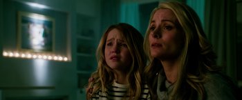 Movie still from “Geostorm” (2017), directed by Dean Devlin – A woman and a girl are looking at the camera; Close Up shot, Low angle