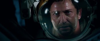 Movie still from “Geostorm” (2017), directed by Dean Devlin – A person wearing a space helmet; Close Up shot, Overhead angle