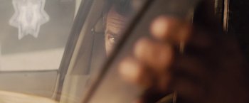 Movie still from “Get the Gringo” (2012), directed by Adrian Grunberg – A man's face looking out a car window; Extreme Close Up shot, Over the shoulder angle