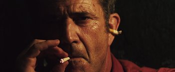 Movie still from “Get the Gringo” (2012), directed by Adrian Grunberg – A person smoking a cigarette; Close Up shot, Low angle