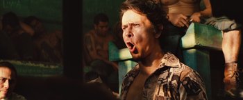 Movie still from “Get the Gringo” (2012), directed by Adrian Grunberg – A man with his mouth wide open in front of another man; Close Up shot, Low angle