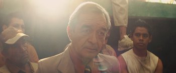 Movie still from “Get the Gringo” (2012), directed by Adrian Grunberg – An old man with a gray beard and a tie; Close Up shot, Over the shoulder angle