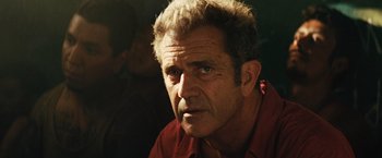 Movie still from “Get the Gringo” (2012), directed by Adrian Grunberg – A person wearing a red shirt; Close Up shot, Over the shoulder angle
