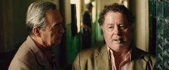 Movie still from “Get the Gringo” (2012), directed by Adrian Grunberg – Two men are talking and one has a cigarette in his mouth; Close Up shot, Over the shoulder angle