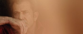 Movie still from “Get the Gringo” (2012), directed by Adrian Grunberg – An old man with a beard is looking at the camera; Extreme Close Up shot, Low angle