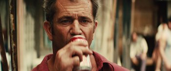 Movie still from “Get the Gringo” (2012), directed by Adrian Grunberg – A person drinking a can of soda; Close Up shot, Over the shoulder angle