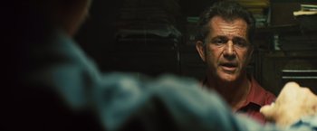 Movie still from “Get the Gringo” (2012), directed by Adrian Grunberg – A person in a garage; Close Up shot, Over the shoulder angle