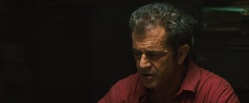 Movie still from “Get the Gringo” (2012), directed by Adrian Grunberg – A person wearing a red shirt; Close Up shot, Low angle