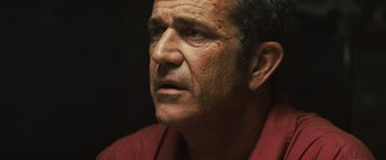 Movie still from “Get the Gringo” (2012), directed by Adrian Grunberg – An older man looking into the distance with a serious look on his face; Close Up shot, Over the shoulder angle
