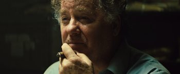 Movie still from “Get the Gringo” (2012), directed by Adrian Grunberg – An older man smoking a cigarette while looking off into the distance; Close Up shot, Low angle
