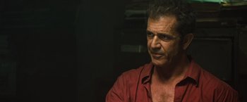 Movie still from “Get the Gringo” (2012), directed by Adrian Grunberg – A person wearing a red shirt; Close Up shot, Over the shoulder angle