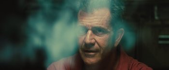 Movie still from “Get the Gringo” (2012), directed by Adrian Grunberg – A person with a blurry background; Close Up shot, Over the shoulder angle