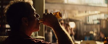 Movie still from “Get the Gringo” (2012), directed by Adrian Grunberg – A man is drinking a beer from a bottle; Close Up shot, Low angle