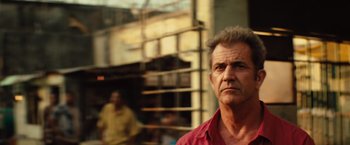 Movie still from “Get the Gringo” (2012), directed by Adrian Grunberg – A person wearing a red shirt; Close Up shot, Low angle