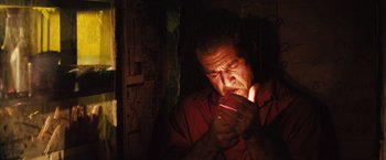 Movie still from “Get the Gringo” (2012), directed by Adrian Grunberg – A man holding a cell phone up to his face; Close Up shot, Low angle