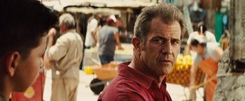 Movie still from “Get the Gringo” (2012), directed by Adrian Grunberg – A person wearing a red shirt; Close Up shot, Over the shoulder angle