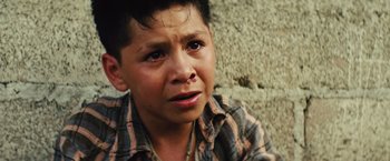 Movie still from “Get the Gringo” (2012), directed by Adrian Grunberg – A young boy with a nose ring looking at the camera; Close Up shot, High angle