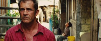 Movie still from “Get the Gringo” (2012), directed by Adrian Grunberg – A person wearing a red shirt; Close Up shot, Over the shoulder angle