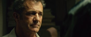 Movie still from “Get the Gringo” (2012), directed by Adrian Grunberg – An older man with grey hair looking at the camera; Close Up shot, Over the shoulder angle