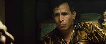 Movie still from “Get the Gringo” (2012), directed by Adrian Grunberg – A person wearing a shirt and a necklace; Close Up shot, Low angle