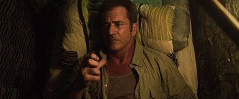 Movie still from “Get the Gringo” (2012), directed by Adrian Grunberg – A person laying on a bed smoking a cigarette; Close Up shot, High angle