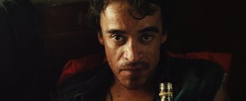 Movie still from “Get the Gringo” (2012), directed by Adrian Grunberg – A person with a bottle; Close Up shot, Low angle