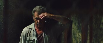 Movie still from “Get the Gringo” (2012), directed by Adrian Grunberg – An older man is looking at the side of his face; Close Up shot, Over the shoulder angle