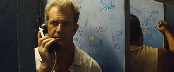 Movie still from “Get the Gringo” (2012), directed by Adrian Grunberg – A man is standing in front of a wall; Close Up shot, Low angle