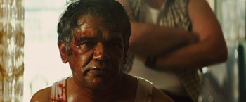 Movie still from “Get the Gringo” (2012), directed by Adrian Grunberg – A person with blood on his face; Close Up shot, Over the shoulder angle