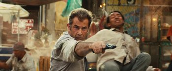 Movie still from “Get the Gringo” (2012), directed by Adrian Grunberg – A man holding a remote control in his hand; Medium shot, Low angle