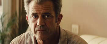 Movie still from “Get the Gringo” (2012), directed by Adrian Grunberg – An older man is looking at the camera; Close Up shot, Over the shoulder angle