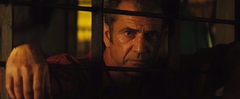 Movie still from “Get the Gringo” (2012), directed by Adrian Grunberg – A person behind a fence; Close Up shot, Low angle