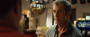 Movie still from “Get the Gringo” (2012), directed by Adrian Grunberg – An older man is looking at the camera in a room; Close Up shot, Over the shoulder angle