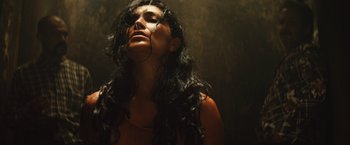 Movie still from “Get the Gringo” (2012), directed by Adrian Grunberg – A woman with long black hair is looking up; Close Up shot, Overhead angle