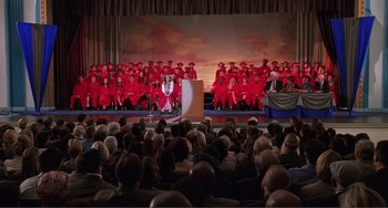Movie still from “Ghost World” (2001), directed by Terry Zwigoff – A crowd of people sitting in front of a podium; Extreme Wide shot, High angle