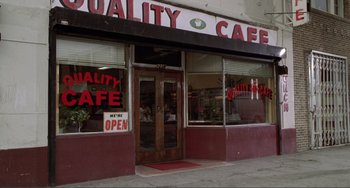 Movie still from “Ghost World” (2001), directed by Terry Zwigoff – A cafe with a red and white sign on the door; Wide shot, High angle