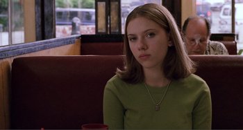 Movie still from “Ghost World” (2001), directed by Terry Zwigoff – A girl sitting at a table in a restaurant; Close Up shot, Over the shoulder angle