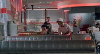 Movie still from “Ghost World” (2001), directed by Terry Zwigoff – A man and a woman are sitting at a counter; Wide shot, Over the shoulder angle