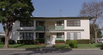 Movie still from “Ghost World” (2001), directed by Terry Zwigoff – A building that has been painted white and green; Extreme Wide shot, Low angle