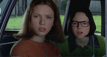 Movie still from “Ghost World” (2001), directed by Terry Zwigoff – Two young people standing next to each other in a car; Close Up shot, Low angle