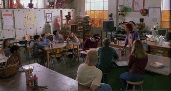 Movie still from “Ghost World” (2001), directed by Terry Zwigoff – A group of people sitting at tables in a room; Wide shot, High angle
