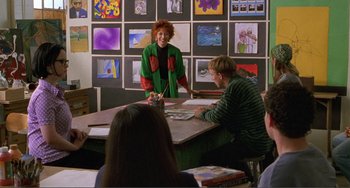 Movie still from “Ghost World” (2001), directed by Terry Zwigoff – A group of people sitting around a table; Wide shot, Over the shoulder angle