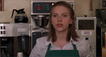 Movie still from “Ghost World” (2001), directed by Terry Zwigoff – A woman wearing an apron in front of a coffee maker; Close Up shot, Over the shoulder angle