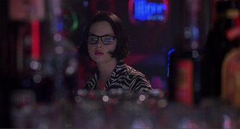 Movie still from “Ghost World” (2001), directed by Terry Zwigoff – A woman sitting at a table in front of drinks; Close Up shot, Over the shoulder angle