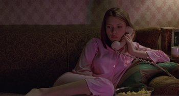 Movie still from “Ghost World” (2001), directed by Terry Zwigoff – A woman sitting on a couch talking on the phone; Medium shot, High angle