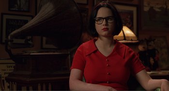 Movie still from “Ghost World” (2001), directed by Terry Zwigoff – A woman in a red shirt is sitting in front of a record player; Medium shot, Low angle