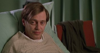 Movie still from “Ghost World” (2001), directed by Terry Zwigoff – A man sitting in a hospital bed looking at the camera; Close Up shot, High angle