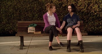 Movie still from “Ghost World” (2001), directed by Terry Zwigoff – Two people sitting on a bench on the sidewalk; Medium shot, High angle